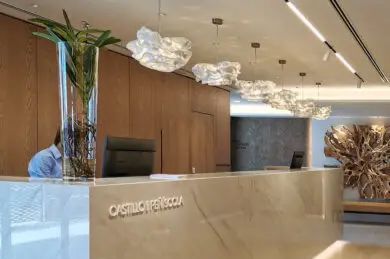 Hotel reception with handcrafted light fixtures and interior design in warm tones.
